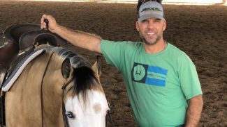 Craig Schmersal standing by horse