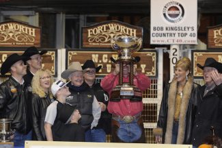 People holding up the NCHA futurity cup an award that comes with great prestige