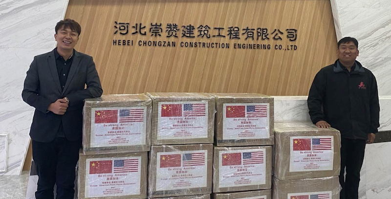 BoZhan Wei, owner of Ba Jun Heng Tong Equine Club, left, stands with boxed medical supplies.